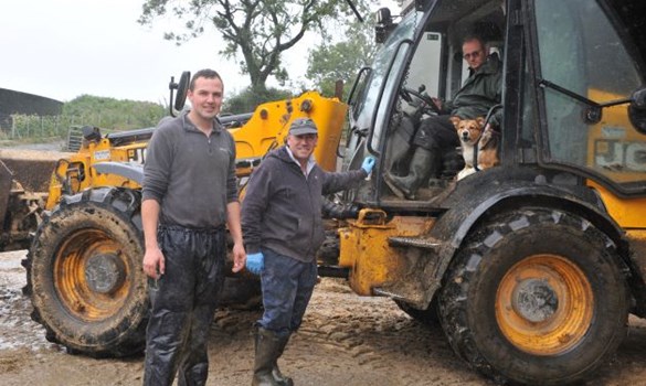 a group of men standing next to a truck
